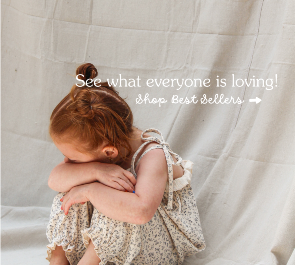 Child in a floral dress holding a matching bag against a neutral background with text overlay.